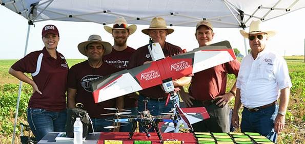 Members of Agrilife research holding UAV drones