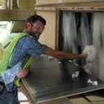 Assistant Professor Robert Hardin collecting cotton from gin